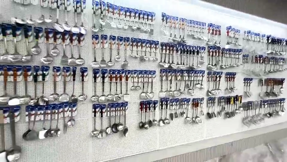 Wall of stainless steel cutlery samples in the showroom
