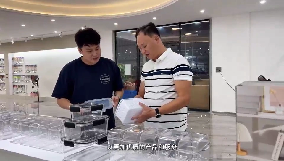 Two people reviewing lunchware products in the showroom