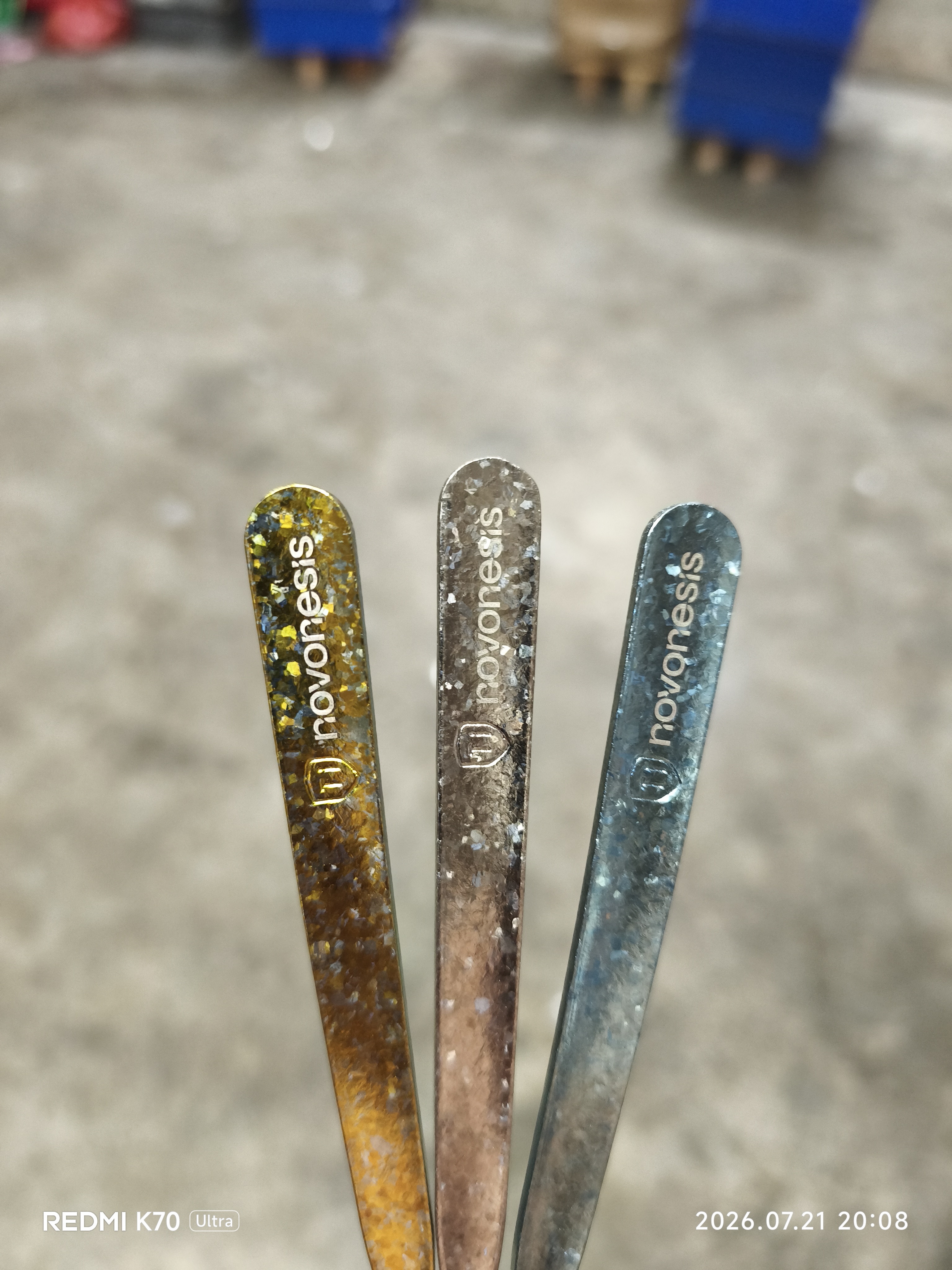 Finished logo marking on spoon handles on white background